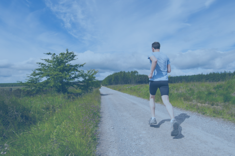 adult man running down road