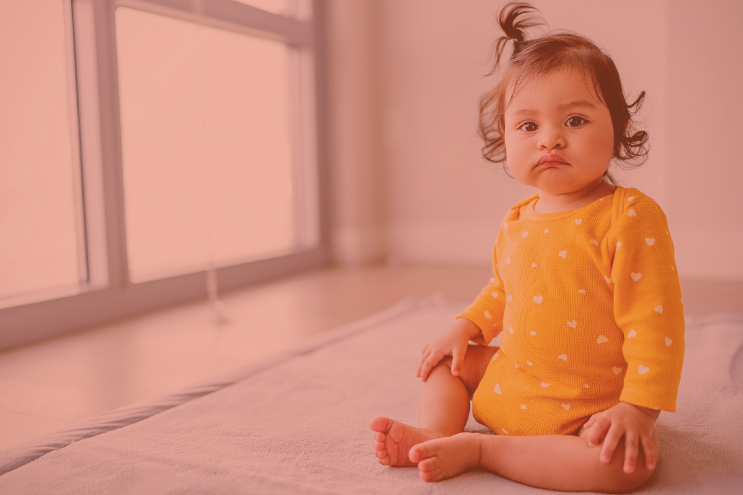 a baby sitting on the floor