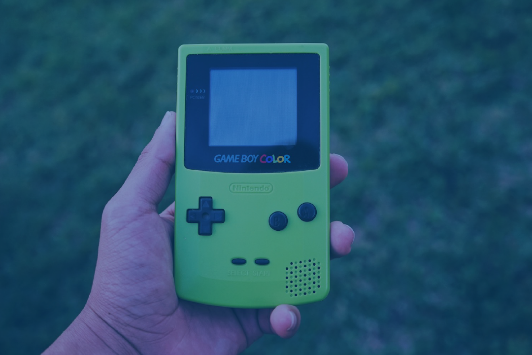 a man holding a gameboy color